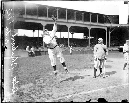 Baseball player J. T. Sheckard, jumping in the air to catch a baseball on the field at West Side Grounds - Chicago Daily News, Inc.