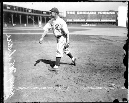Baseball player McIntire, Cubs, following through after throwing a baseball on the field at West Side Grounds - Chicago Daily News, Inc.