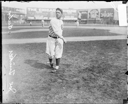 Baseball player Joe Tinker, Cubs, following through after throwing a baseball on the field at West Side Grounds - Chicago Daily News, Inc.