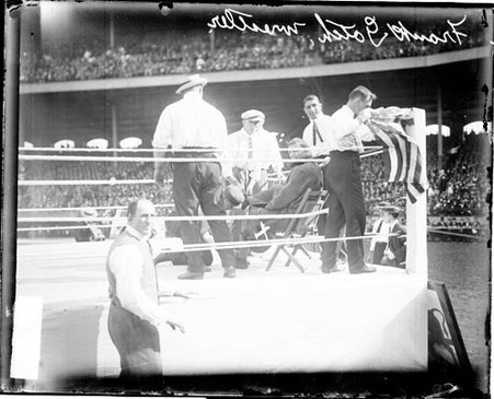 Wrestler Gotch looking at the camera, sitting on a chair in a corner of a wrestling ring on the field at Comiskey Park - Chicago Daily News, Inc.