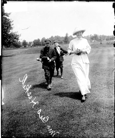 Golfer Mrs George S Haskell walking on the grounds of an unidentified golf course - Chicago Daily News, Inc.