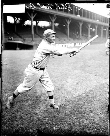 Baseball player Cravath, Phillies, following through after swinging a baseball bat on the field at West Side Grounds - Chicago Daily News, Inc.