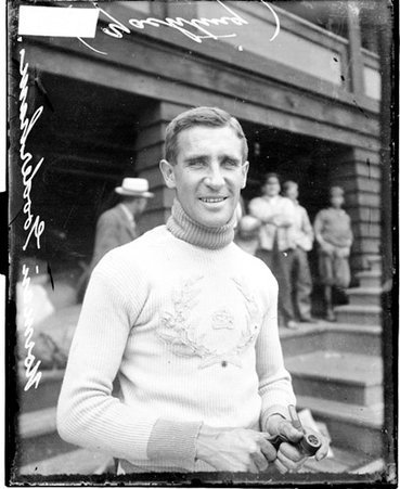 Yachtsman Herman Gooderham holding a pipe, standing in front of a building - Chicago Daily News, Inc.