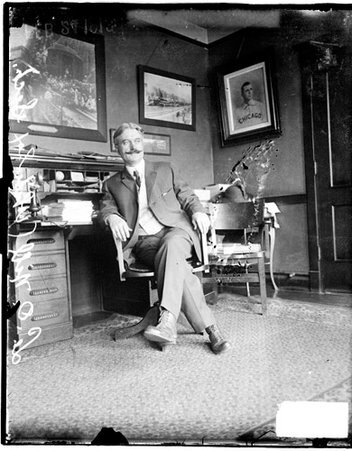 L O Nill, secretary White Sox, sitting at a desk in a room - Chicago Daily News, Inc.