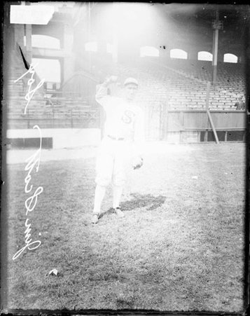 Baseball player, Jim Scott, White Sox, cocking his arm to throw a baseball at Comiskey Park - Chicago Daily News, Inc.