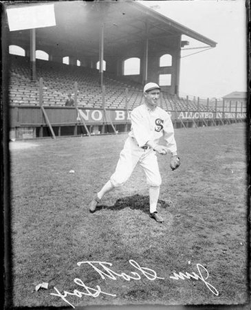 Baseball player, Jim Scott, White Sox, holding a baseball and leaning forward on the field at Comiskey Park - Chicago Daily News, Inc.