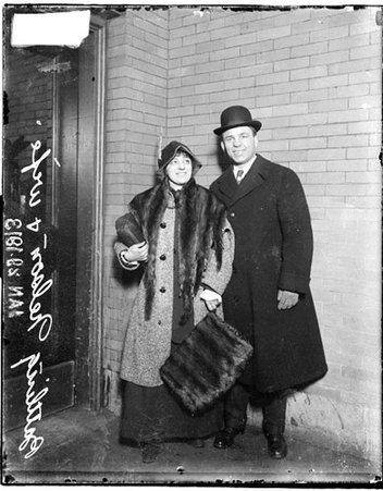 Boxer, Battling Nelson, standing with his wife in front of a brick wall - Chicago Daily News, Inc.