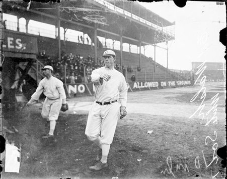 Baseball player, Walsh, White Sox, following through after throwing a baseball on the field at South Side Park - Chicago Daily News, Inc.