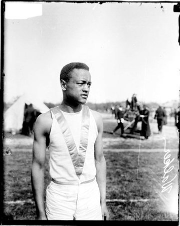African American athlete Walker standing on an athletic field - Chicago Daily News, Inc.