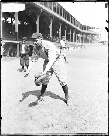 Unidentified baseball player, Phillies, standing in front of grandstands at West Side Grounds - Chicago Daily News, Inc.
