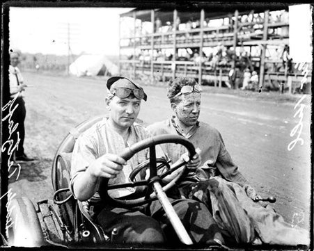 Automobile driver Tetzlaff and mechanic G Hill sitting in an automobile parked on a road - Chicago Daily News, Inc.