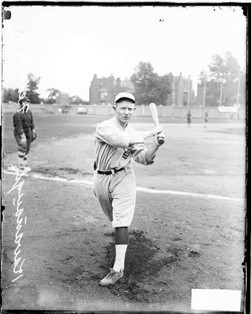 Federal League Baseball player, following through after swinging a baseball bat, standing in foul territory - Chicago Daily News, Inc.