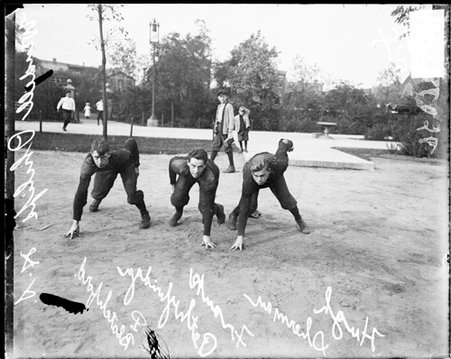 Wendell Phillips High School football players Sherman, Blatchford, and Pethbridge, standing in ready positions - Chicago Daily News, Inc.