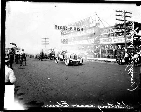 Automobile driver R Mulford starting a Knox automobile at the start-finish line on a road during Elgin Auto Races - Chicago Daily News, Inc.