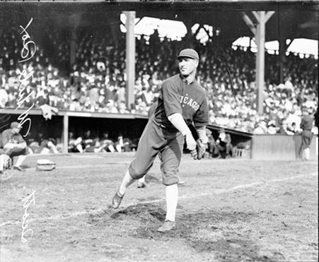 Baseball player, Scott, White Sox, standing in front of a dugout and grandstands on the field at West Side Grounds - Chicago Daily News, Inc.
