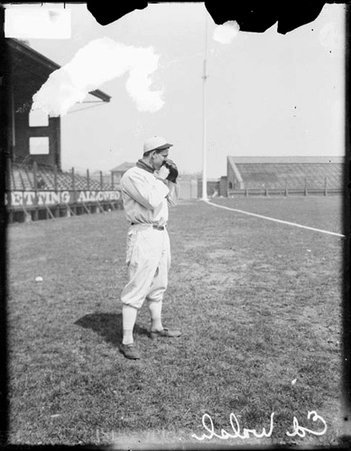 Baseball player, Walsh, White Sox, holding his glove over his mouth and nose on the field at Comiskey Park - Chicago Daily News, Inc.