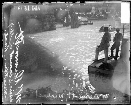 Swimmer McDermott swimming in the Chicago River en route to winning second place in a river swimming marathon - Chicago Daily News, Inc.