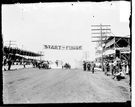 Two unidentified automobile drivers driving from the starting line on a road in Elgin, during an automobile race - Chicago Daily News, Inc.