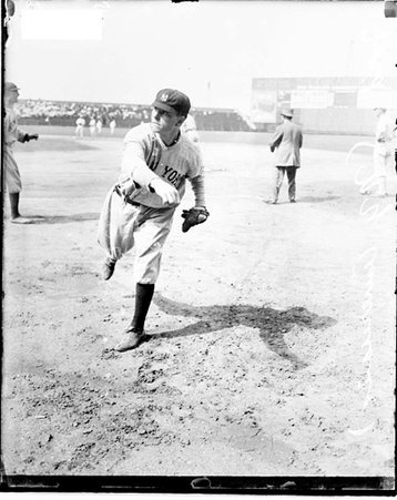 Baseball player Ford, New York Yankees, following through after throwing a baseball on the field at Comiskey Park - Chicago Daily News, Inc.