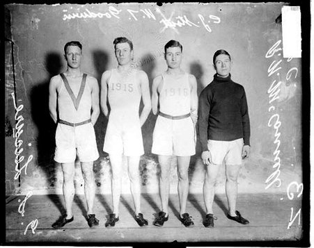 University of Chicago athletes McConnell, Stout, Goodwin, and Leisure standing in front of a light-colored backdrop in a room - Chicago Daily News, Inc.
