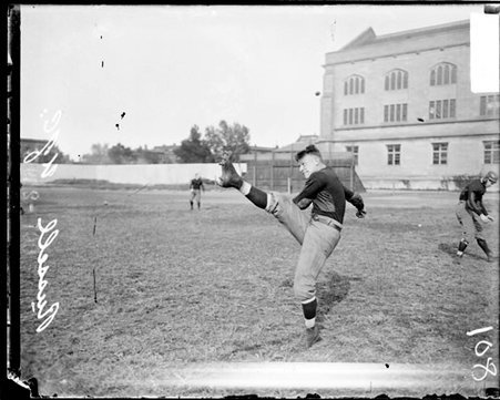 University of Chicago football player Russell following through after kicking a football on the field at Marshall Field - Chicago Daily News, Inc.