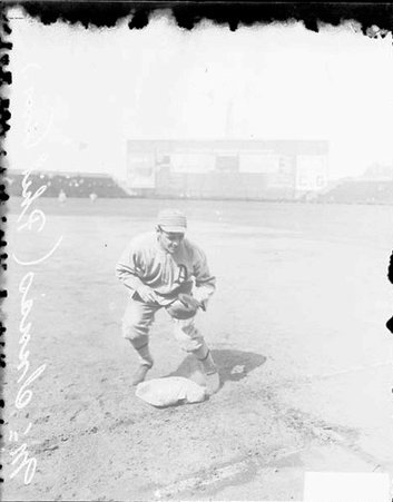 Baseball player McInnis, Philadelphia Athletics crouching down at first base at Comiskey Park - Chicago Daily News, Inc.