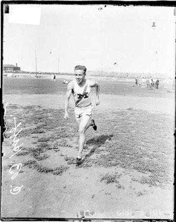 Athlete C. B. Haff running towards the camera on an athletic field - Chicago Daily News, Inc.