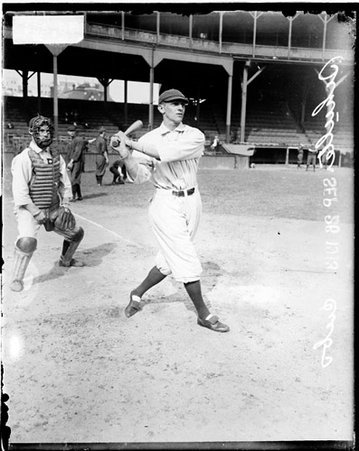 Baseball player Frank Schulte of the Cubs following through after swinging a baseball bat, on the field at West Side Grounds - Chicago Daily News, Inc.