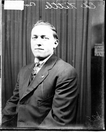 Bowler, Ed Nittle sitting in front of a dark backdrop in a room - Chicago Daily News, Inc.