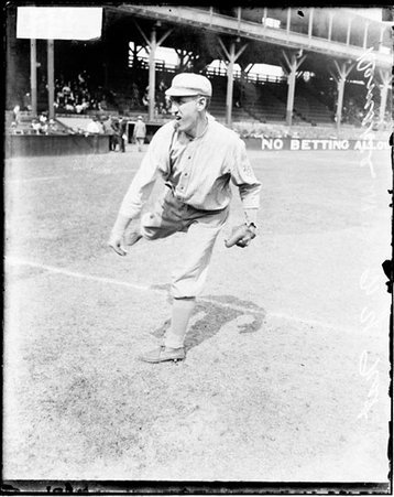 Baseball player, Demaree, New York Giants, following through after throwing a baseball on the field at West Side Grounds - Chicago Daily News, Inc.