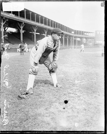 Baseball catcher Burns, Philadelphia Phillies, leaning forward with his hands on his knees on the field at West Side Grounds - Chicago Daily News, Inc.