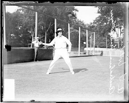 Australian tennis player Anthony E Wilding holding a tennis racket in his right hand on a tennis court - Chicago Daily News, Inc.