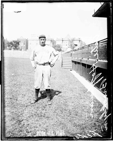Brooklyn Federal League baseball player, Hoffman standing in front of grandstands at Weeghman Park - Chicago Daily News, Inc.