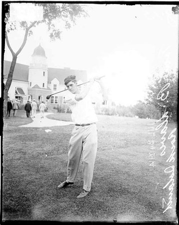 Golfer Davis following through after swinging a golf club - Chicago Daily News, Inc.