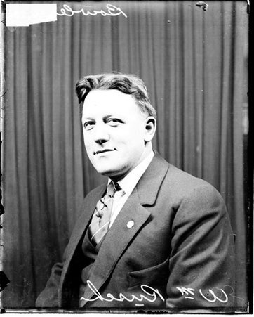 Bowler, William Rusch sitting in front of a dark backdrop in a room - Chicago Daily News, Inc.