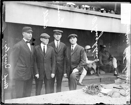Baseball umpires, Eason, Quigley, Chill, and O'Laughlin posing in dugout at Comiskey - Chicago Daily News, Inc.