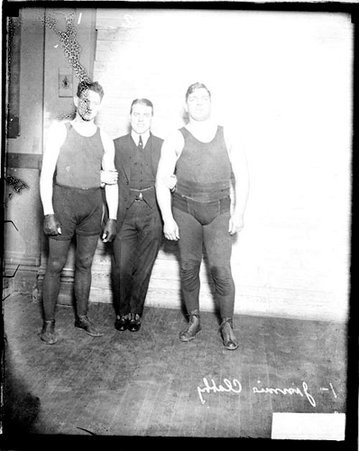 Pugilist, Jimmy Clabby posing with two unidentified men in room - Chicago Daily News, Inc.