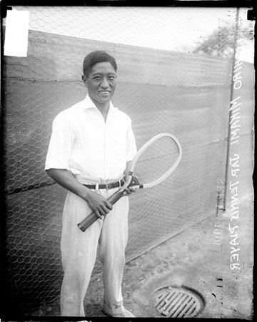 Tennis player, Hachishiro Mikami holding racquet with both hands on tennis court - Chicago Daily News, Inc.