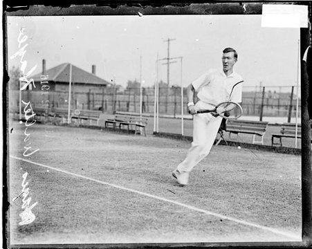 Tennis player, Walter Hayes holding racquet with both hands moving to his left behind baseline - Chicago Daily News, Inc.