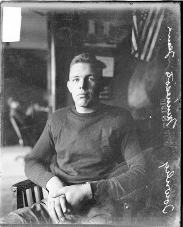 Football player, Minnesota, Townley sitting in chair in office - Chicago Daily News, Inc.