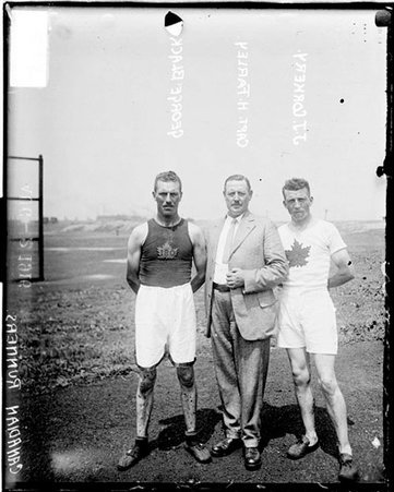 Runners, George Black, J. J. Corkery, and Captain H. Farley standing outside in front of field - Chicago Daily News, Inc.