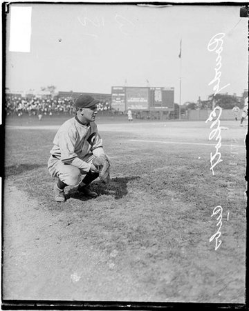 Baseball player, Cubs, Elliott squatting in foul zone at Weeghman Park - Chicago Daily News, Inc.