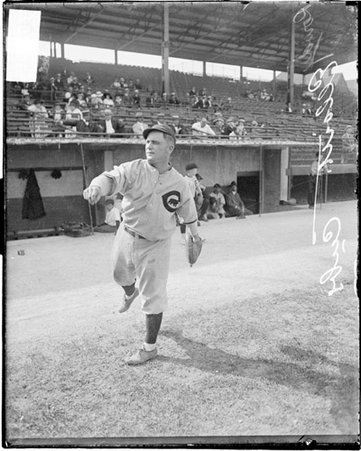 Baseball player, Cubs, Elliott throwing ball standing in front of dugout at Weeghman Park - Chicago Daily News, Inc.