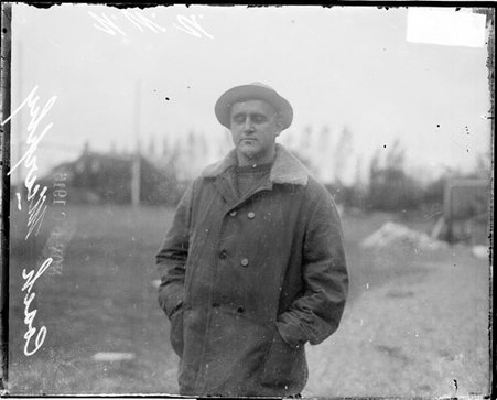 Football coach, Fred Murphy, Northwestern University, standing on an athletic field - Chicago Daily News, Inc.