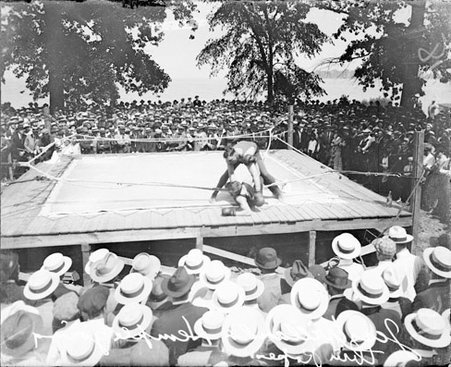 Boxing match, Jess Willard and Hemple, in a lakeside ring with a crowd watching - Chicago Daily News, Inc.