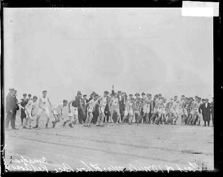 Runners, start of race for Canadian Red Cross fund, runners standing abreast on beach - Chicago Daily News, Inc.