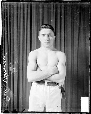 Pugilist, Pete Herman standing in front of dark backdrop - Chicago Daily News, Inc.