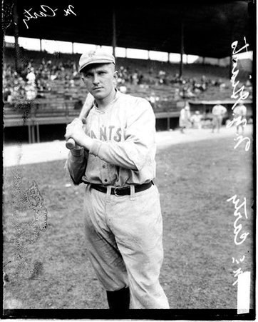 Baseball player, McCarty, New York Giants, holding a baseball bat, standing on the field at Weeghman Field - Chicago Daily News, Inc.