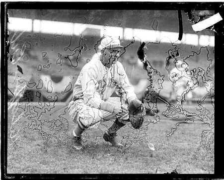 Baseball player, Killefer, Cubs, crouching in front of grandstands on the field at Weeghman Field - Chicago Daily News, Inc.