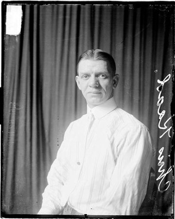 Bowler, Chris Kaad sitting in front of dark backdrop - Chicago Daily News, Inc.